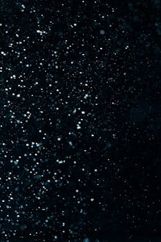Abstract image of water droplets against a dark background, creating a starry night effect.