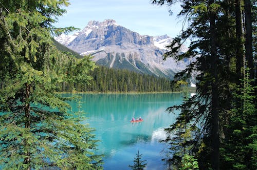 Boat on Crystal Clear Lake in Mountains