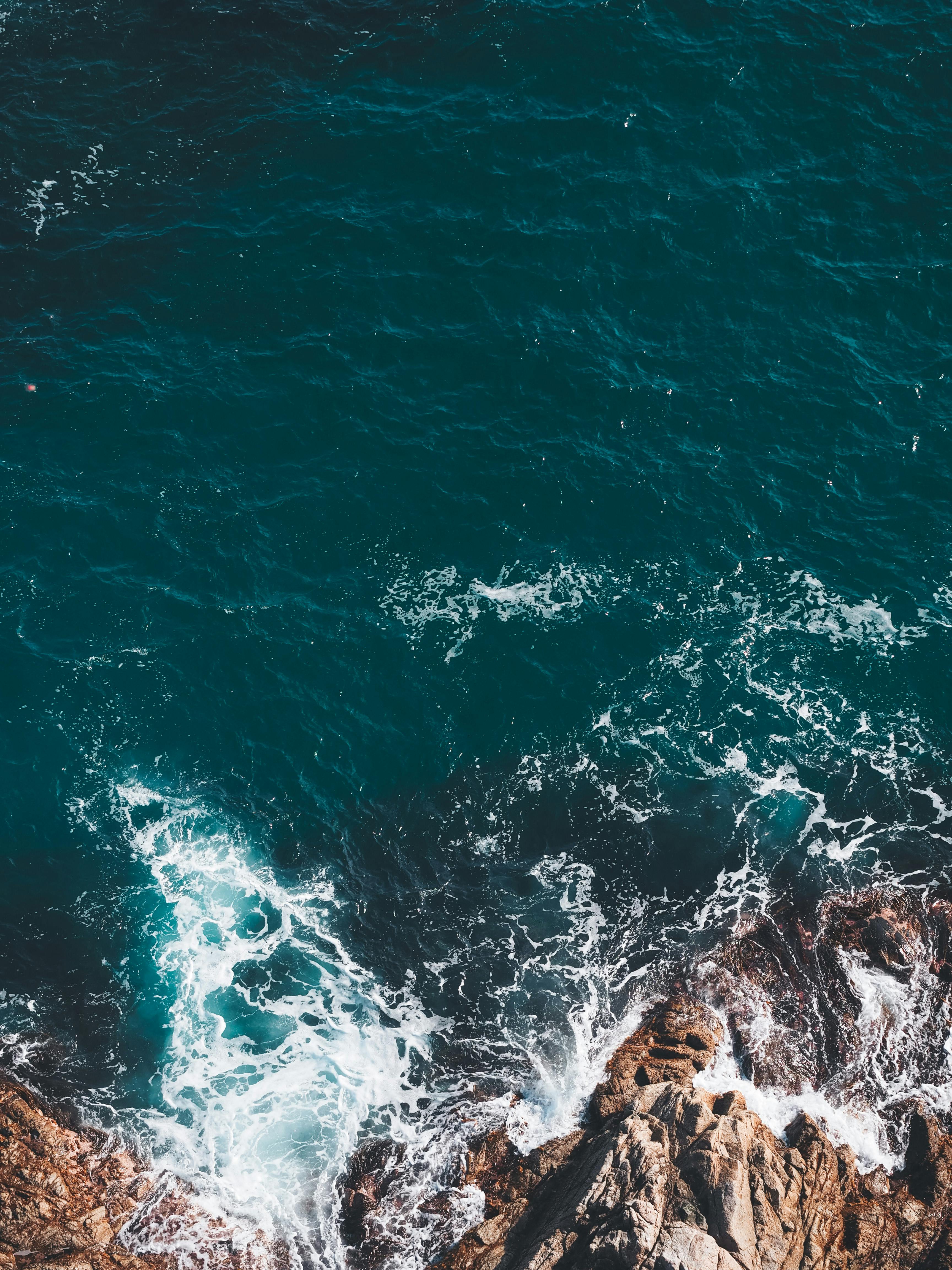 Water Waves Hitting Rock Formations · Free Stock Photo