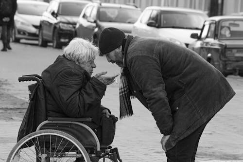 Free Elderly Man Sitting on a Wheelchair Talking to a Friend Stock Photo
