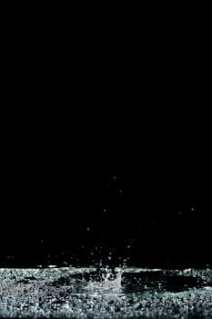 High-speed photograph capturing a water splash against a black backdrop.