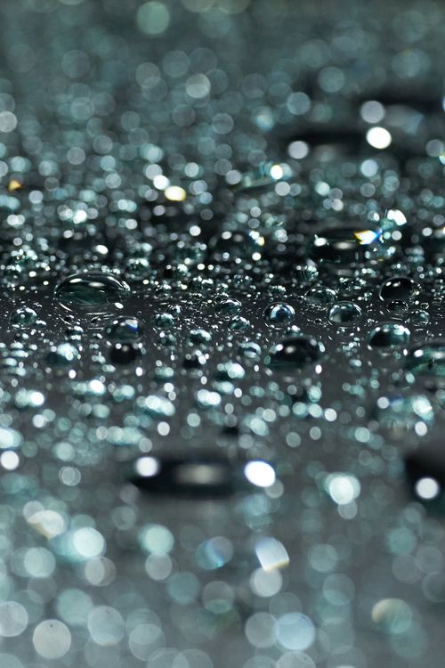 Free Macro shot of water droplets on a reflective surface with a bokeh effect. Stock Photo