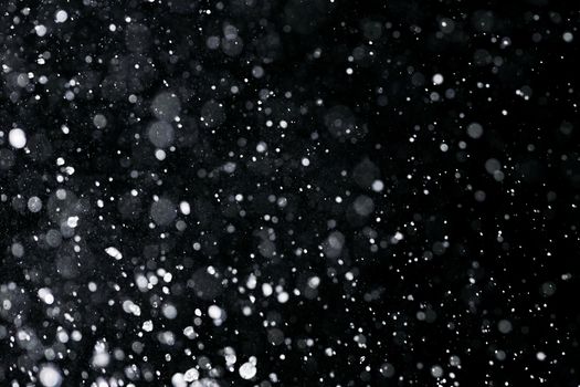 High-speed capture of water droplets with a black background, showcasing textures and visual effects.