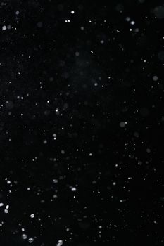 A dramatic high-speed capture of water particles on a black background, ideal for visual effects.