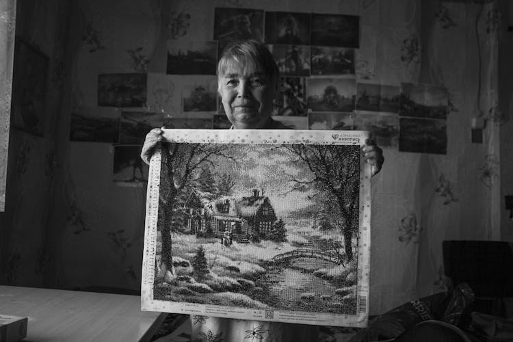 Elderly Woman Holding A Painting