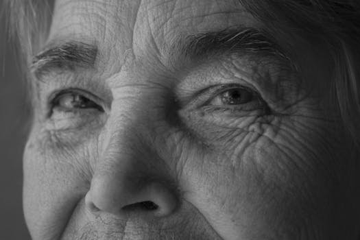 Intimate black and white portrait showing the details of an elderly person's face.