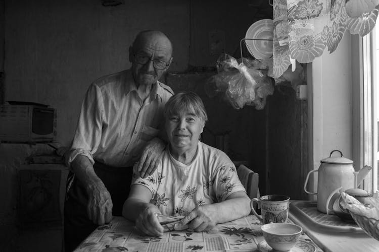 Grayscale Photo Of An Elderly Couple At Home