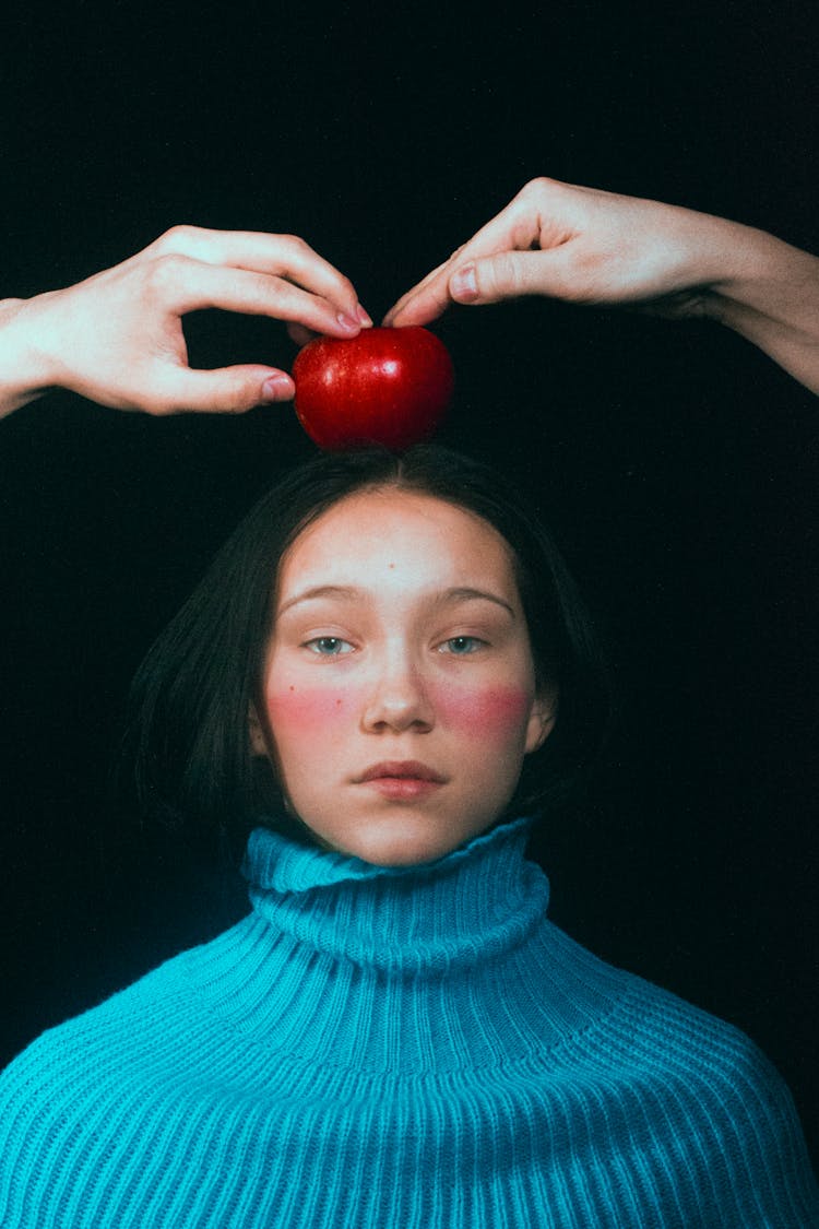 Blue Eyed Woman With An Apple On Her Head