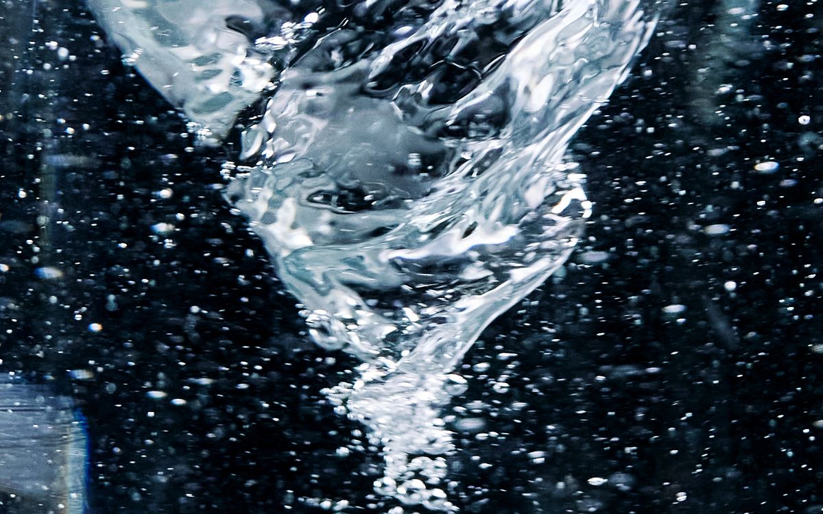Close-up of a swirling water vortex, the kind of spinning fluid motion at the heart of OpenAI's Navier-Stokes blowup proof