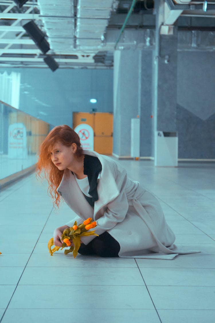 A Woman Kneeling On Tile Floor