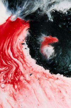Dynamic and colorful abstract fluid art featuring red and black swirls with captivating textures.
