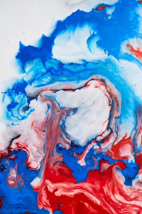 Free Vibrant abstract painting with swirling red, blue, and white hues, showcasing dynamic movement and texture. Stock Photo