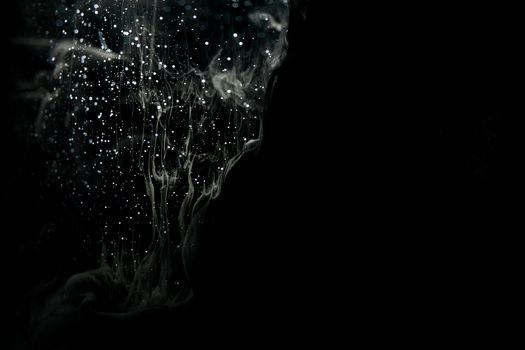 Captivating abstract image of water droplets and swirl patterns on a black background.