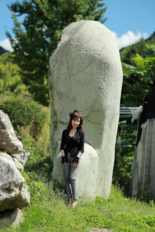 A Beautiful Woman Posing in front of a Boulder