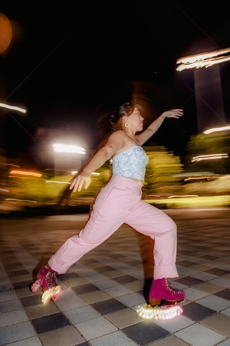 Woman Roller Skating At Night