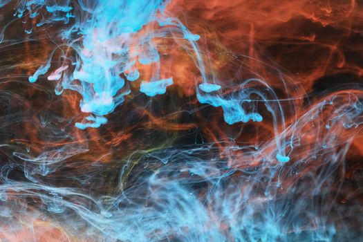 Vivid abstract artwork of swirling blue and orange ink diffusion creating intricate patterns.
