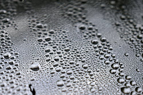 Free Beaded Water Droplets on Black Surface Stock Photo