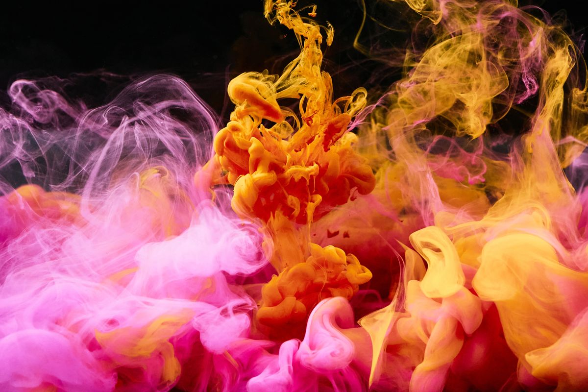 Pink and yellow ink blooming through water, photo by cottonbro studio on Pexels