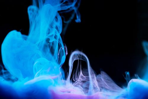 Free Abstract art with flowing blue and purple ink creating a mesmerizing pattern on black backdrop. Stock Photo