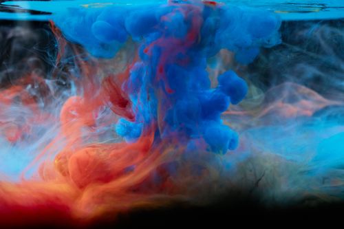 Free Colorful ink swirling underwater creating dynamic patterns. Stock Photo