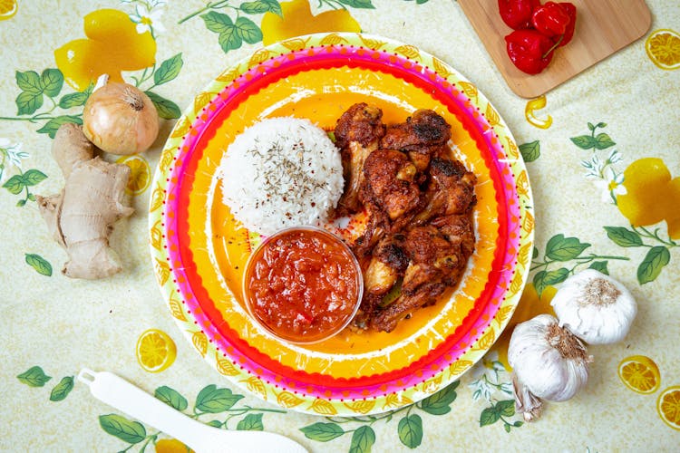 White Rice And Chicken With Sauce On Plate