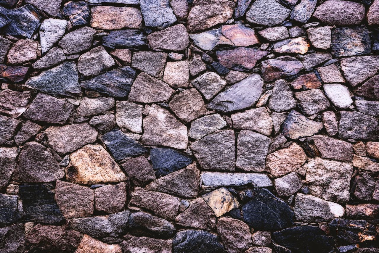 high resolution image of a rustic stone wall showing detailed texture