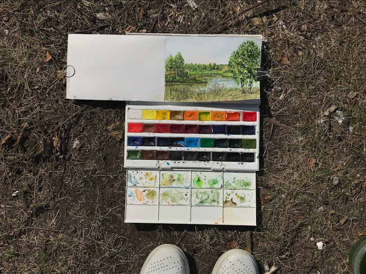 Painting And Watercolor Set On The Ground