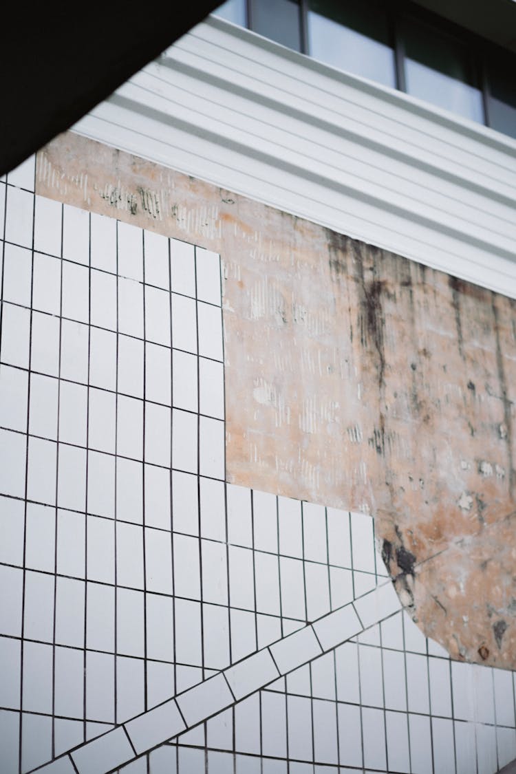 Damaged Wall With White Tiles