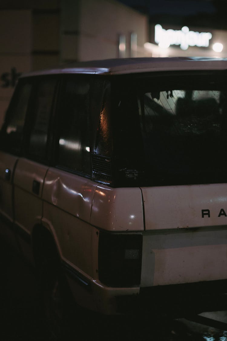 A Vintage Sports Utility Vehicle In A Parking Lot