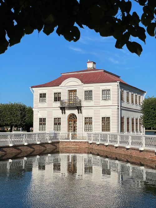 Free Elegant Marly Palace reflecting on a tranquil pond in Saint Petersburg, Russia. Stock Photo