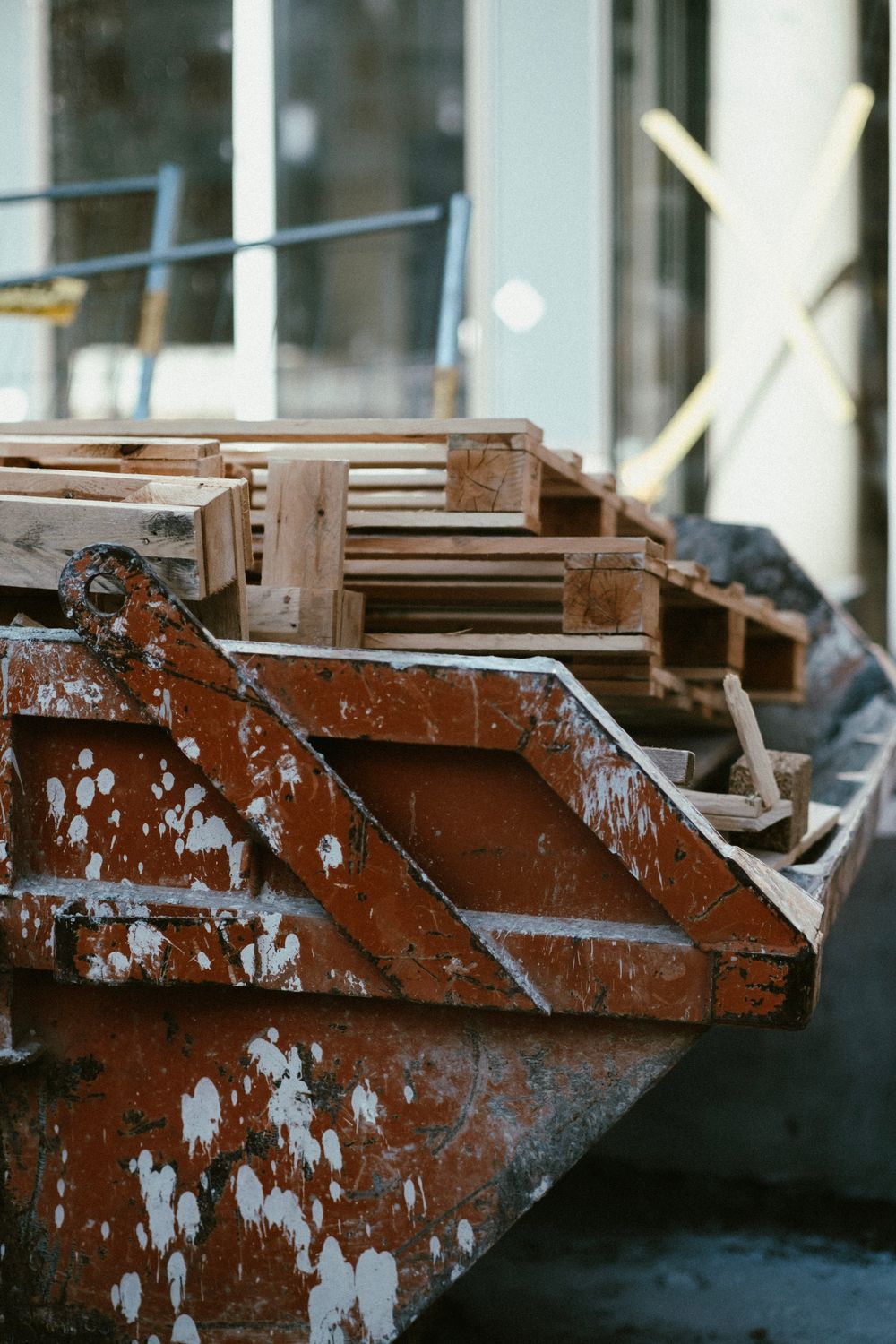 Roll-off dumpster at an active construction job site filled with building debris