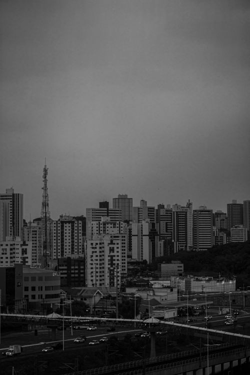 Free A moody grayscale cityscape depicting a dense downtown with modern high-rises. Stock Photo