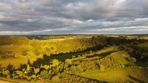 Free Explore the stunning aerial landscape of Sharpenhoe, England featuring rolling hills and lush greenery under dramatic skies. Stock Photo