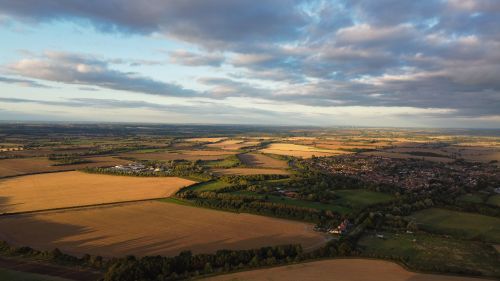Free Serene aerial shot of Sharpenhoe's vast countryside and farmland at sunset, England. Stock Photo