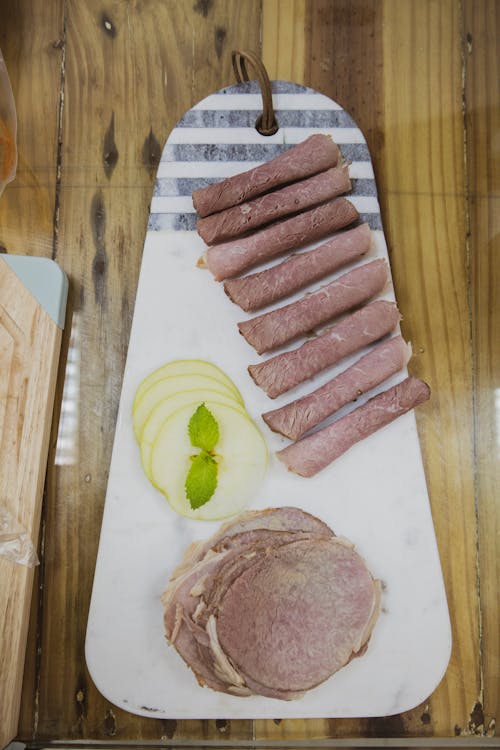 Slices of Ham over a Wooden Board