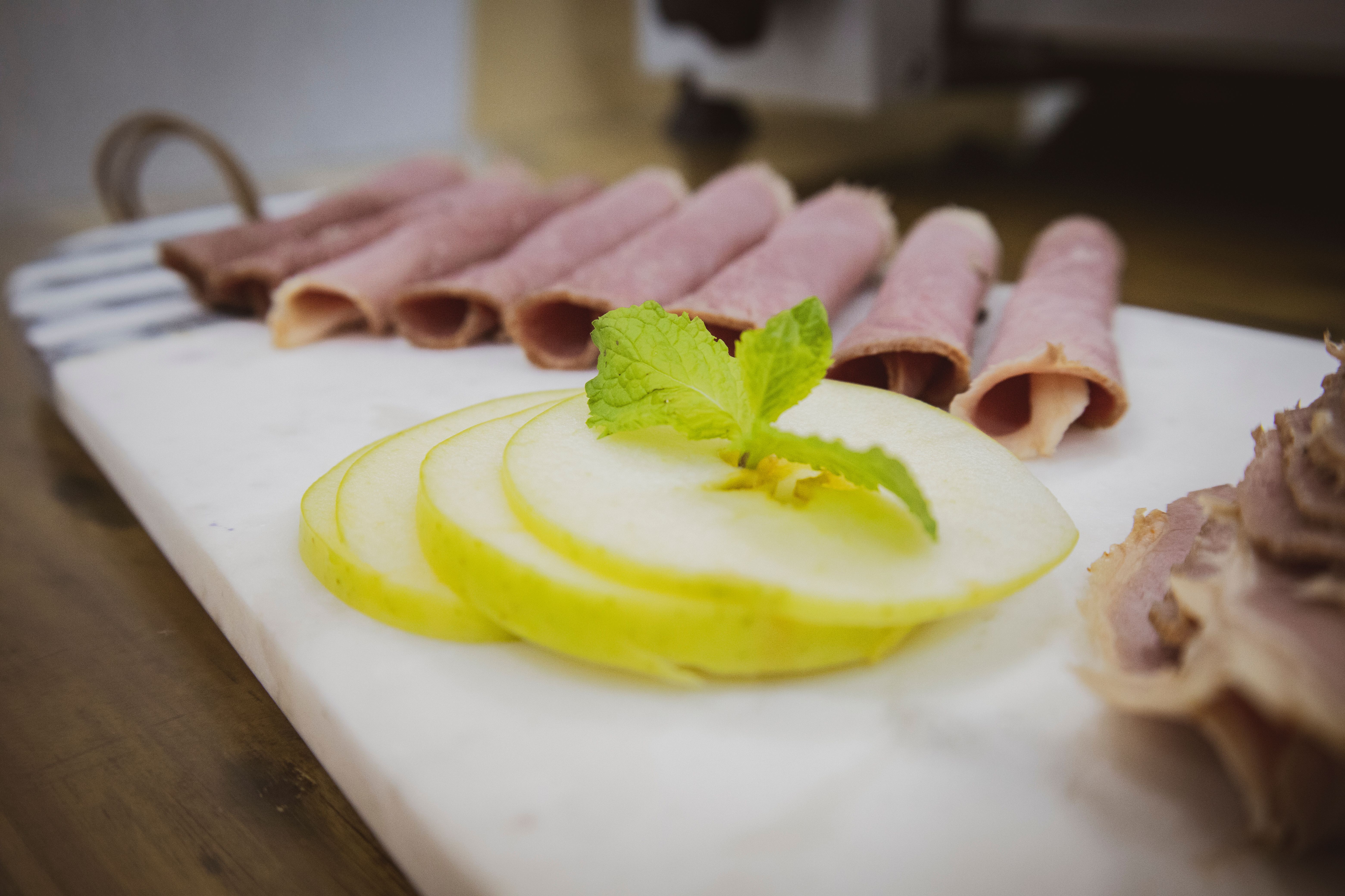 Airtight container with sliced lunch meat inside fridge
