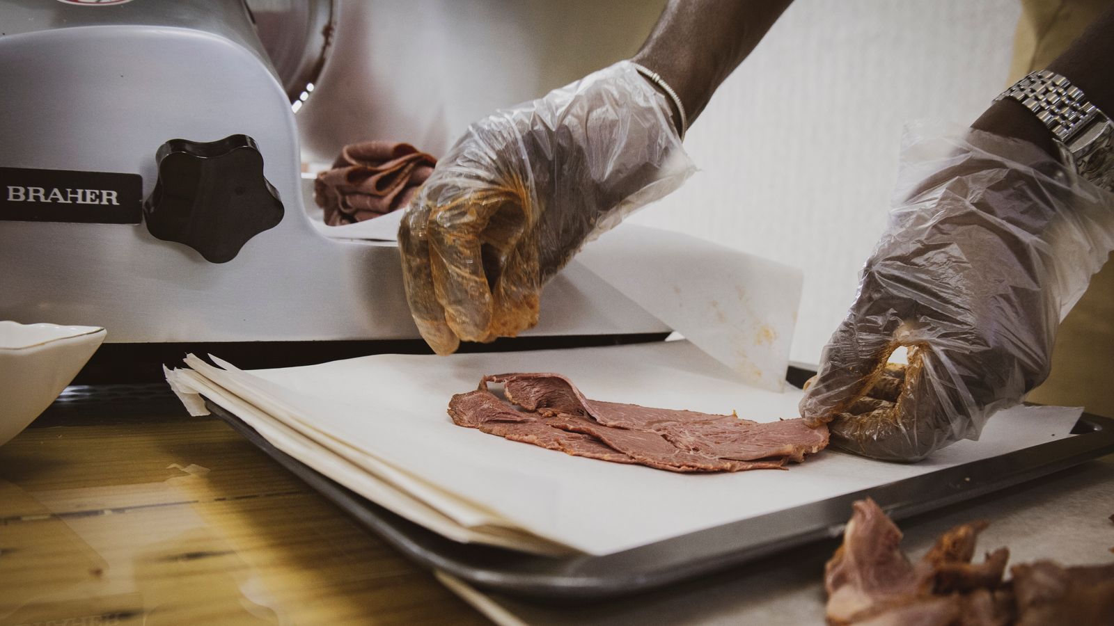 Person slicing meat, Angola