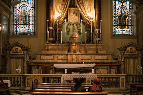 People Sitting on Bench Inside Church