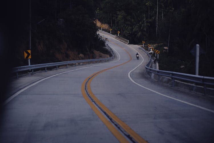 Person Driving Motorcycle On Road