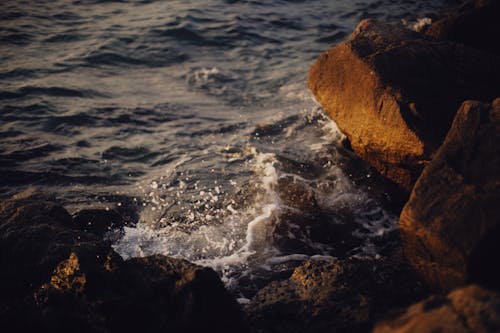 Brown Rock Formation Near Body of Water