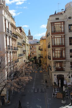 Charming view of a street lined with historic buildings in the heart of Valencia, Spain.