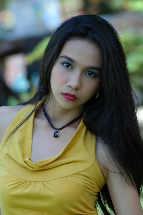 Close-Up Shot of a Pretty Woman in Yellow Top