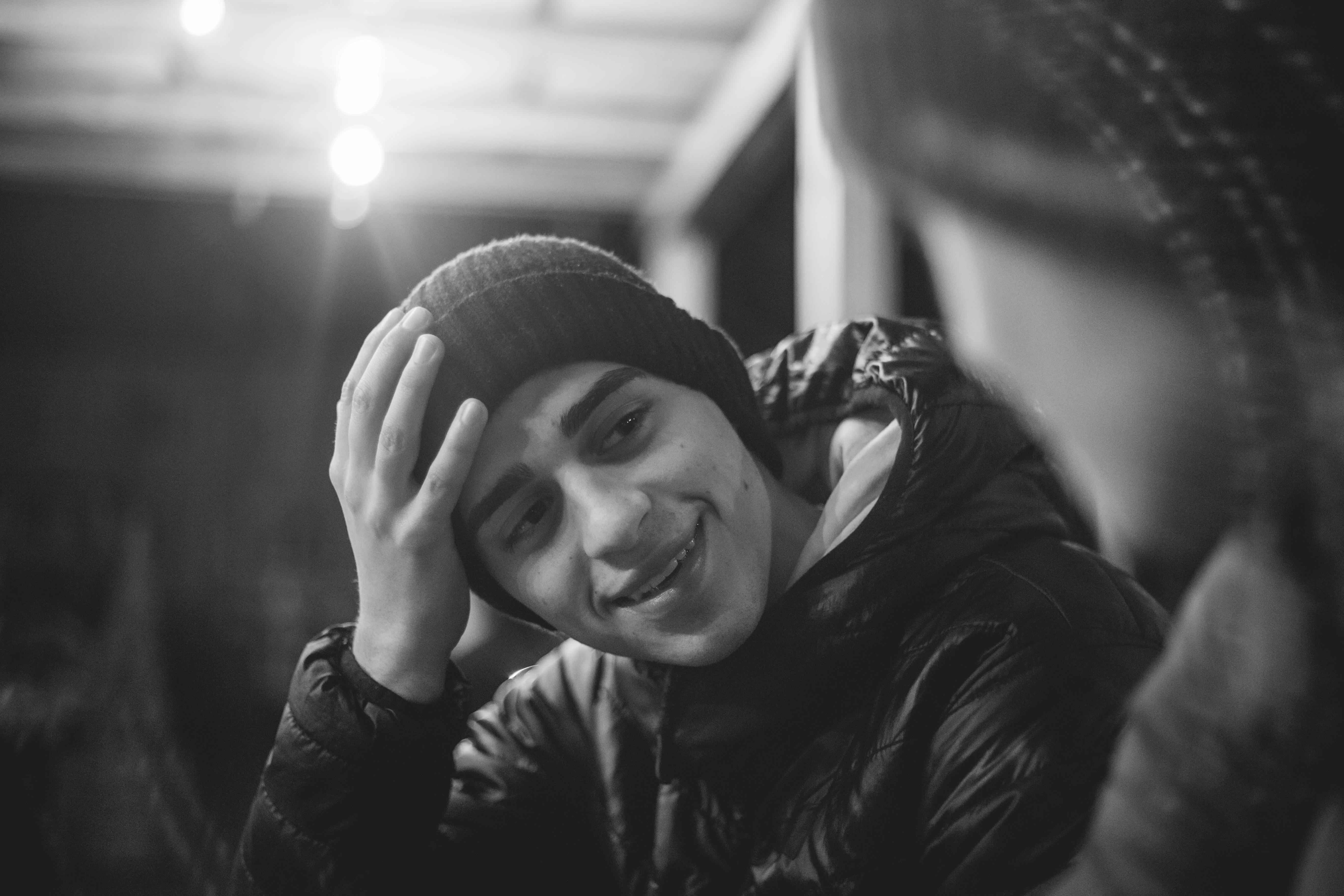 Man Tilting Head and Putting Hand on His Shoulder · Free Stock Photo