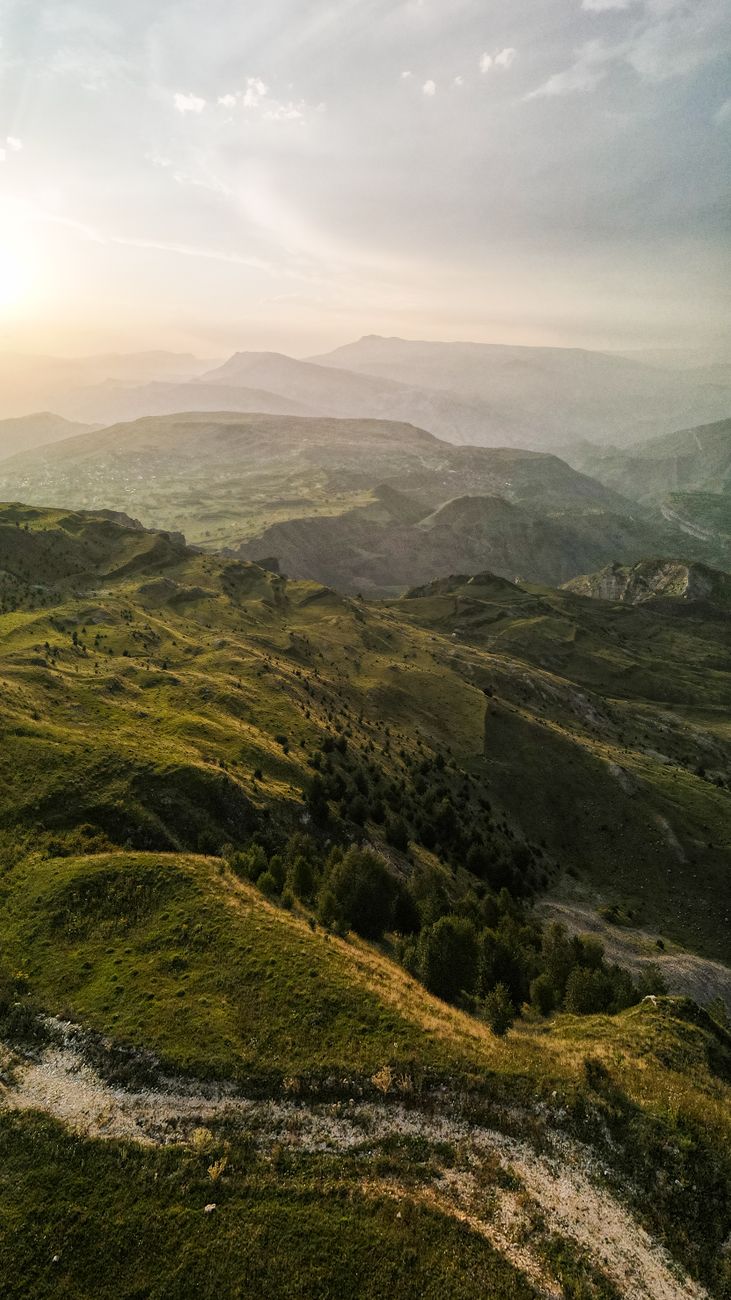 Breathtaking aerial view of mountain ranges in Dagestan at sunset.