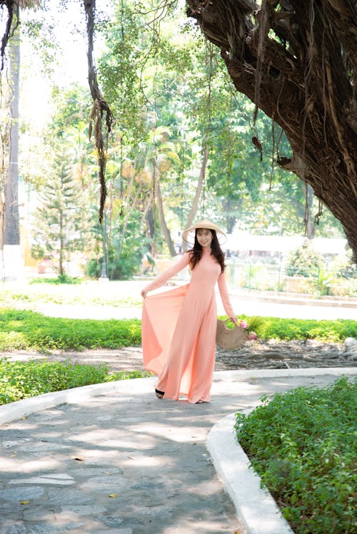 Free Woman in Pink Dress Standing on Walk Path Stock Photo