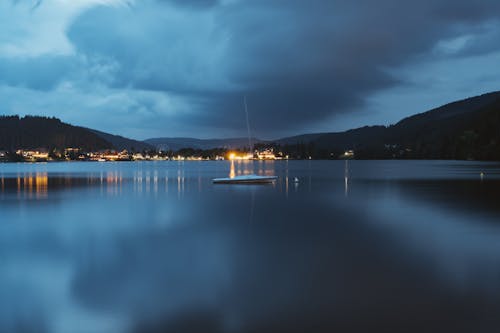 Boat on Lake under Rain Clouds in the Evening