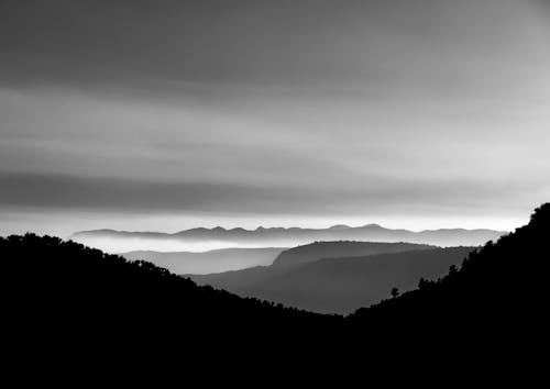Grayscale Photo of Mountain Ranges