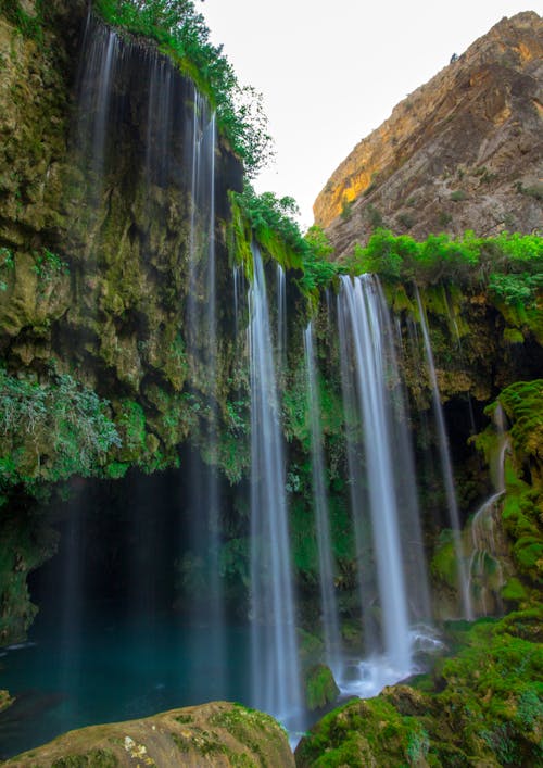 Free Waterfalls in Between Brown Rocky Mountain Stock Photo