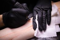 A Person Doing Tattoo
