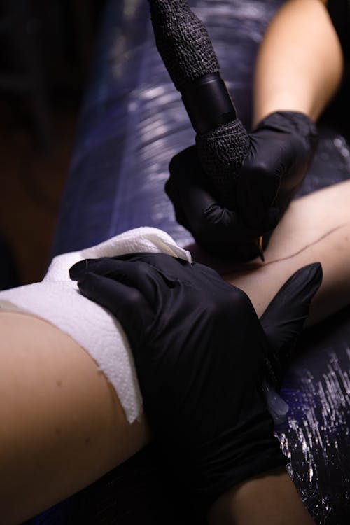 A Person Getting an Arm Tattoo